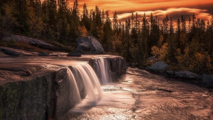 Serene Waterfall at Sunset in Autumn Forest
