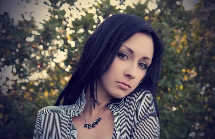 Woman with long black hair and striped shirt