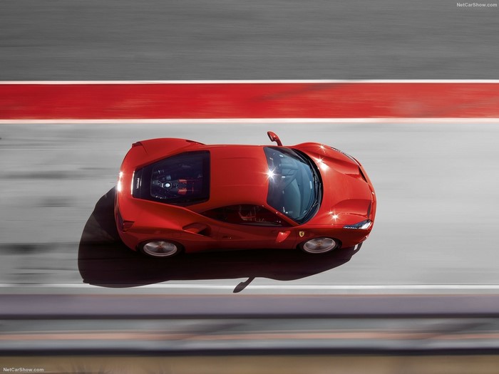 Red Ferrari 488 GTB driving on a race track