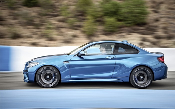 Blue BMW M2 driving on a track