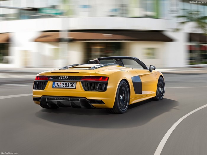 Yellow Audi R8 Spyder driving on a street