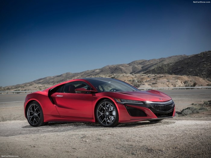 Red Acura NSX parked on a dirt road with mountains