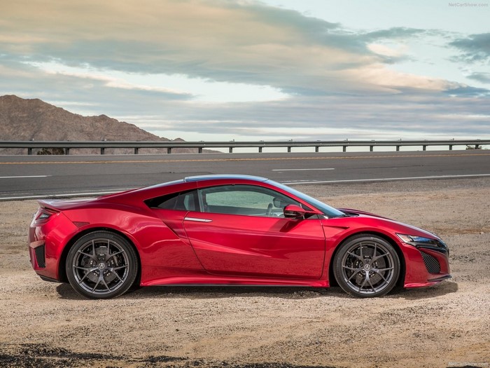 Red Acura NSX sports car parked on dirt road