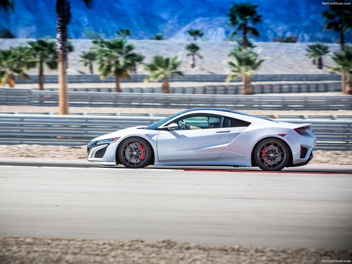 White Acura NSX driving on a race track