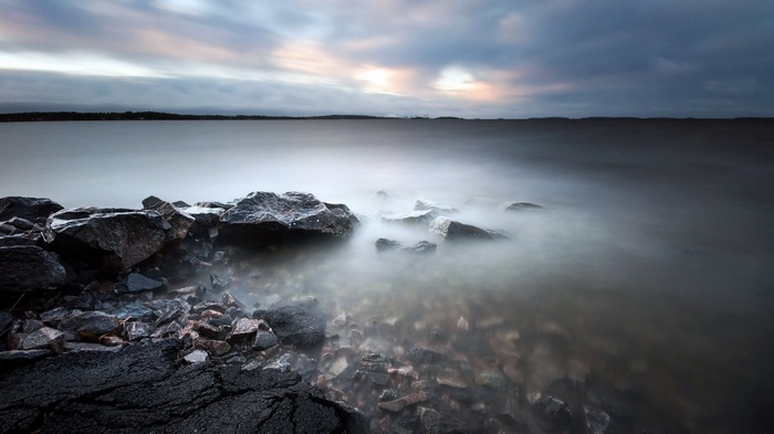 Long exposure of rocky shore and calm water