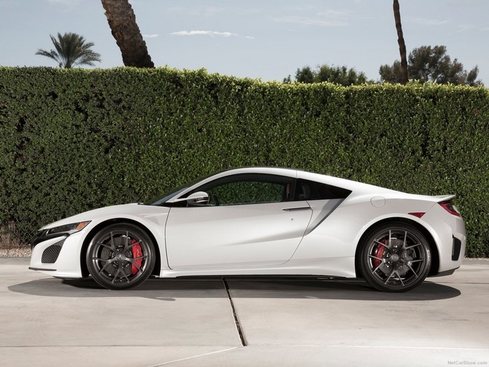 White Acura NSX sports car parked on concrete