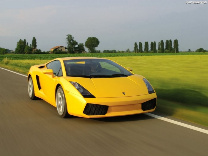 Yellow Lamborghini Gallardo driving on a road