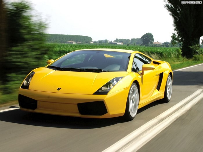 Yellow Lamborghini Gallardo driving on a road