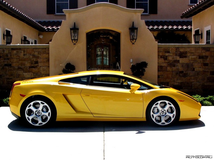 Yellow Lamborghini Gallardo parked in front of a house