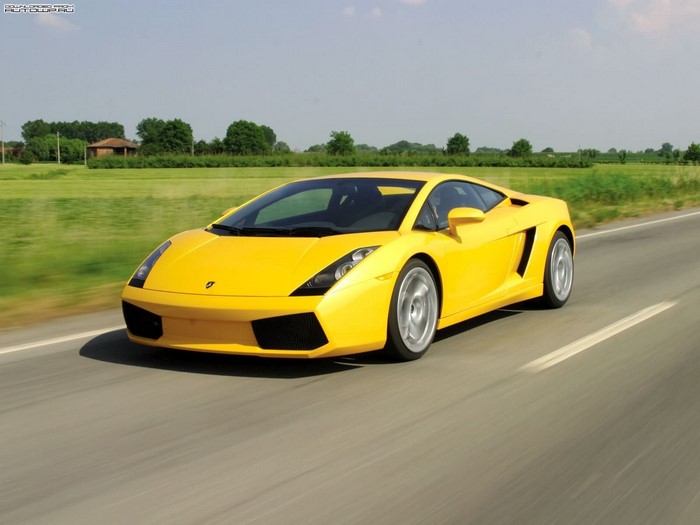 Yellow Lamborghini Gallardo driving on a road
