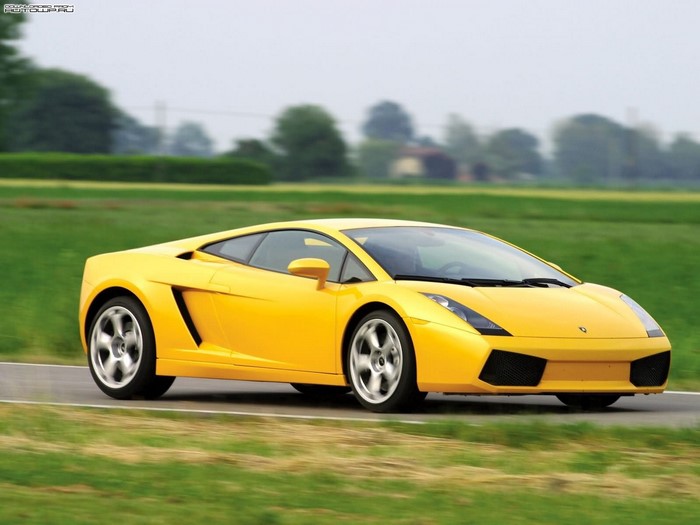 Yellow Lamborghini Gallardo driving on a road