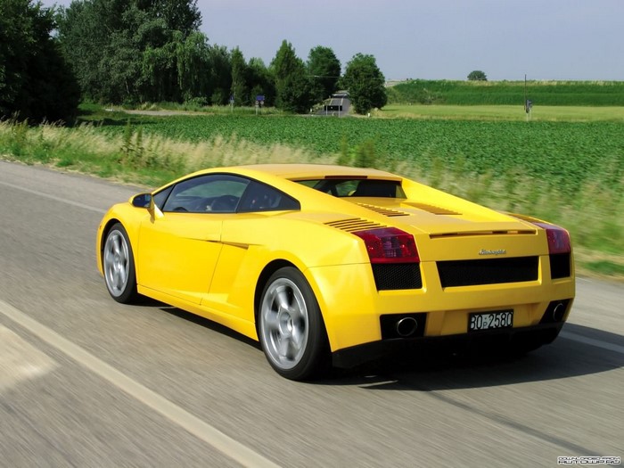 Yellow Lamborghini Gallardo driving on a road