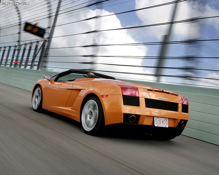 Orange Lamborghini Gallardo convertible driving on a track