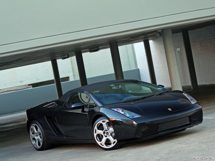 Black Lamborghini Gallardo Spyder parked under a structure