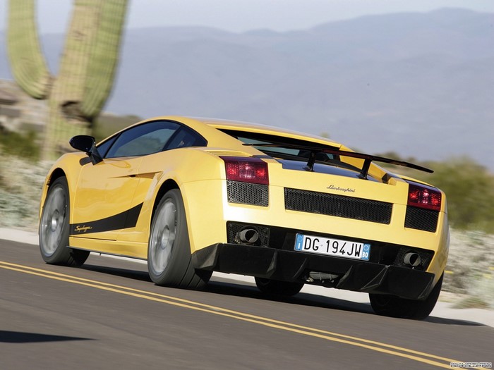 Yellow Lamborghini Gallardo driving on a desert road