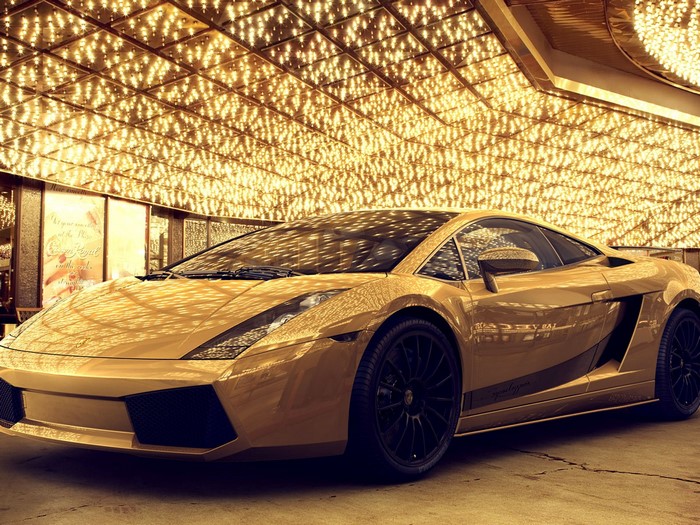 Gold Lamborghini Gallardo parked under golden lights