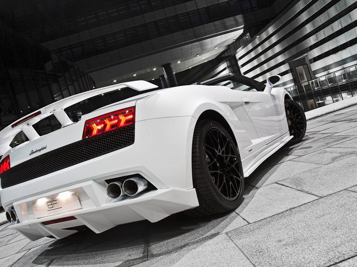 White Lamborghini Gallardo convertible parked outside a modern building