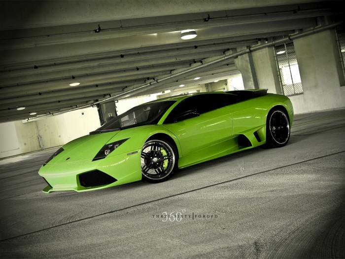 Green Lamborghini Aventador parked in a concrete garage