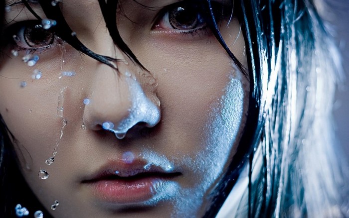 Close up of a woman's face with water drops