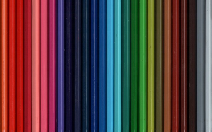 A spectrum of colored pencils arranged vertically