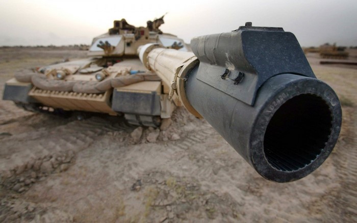 Tank with large cannon in desert landscape
