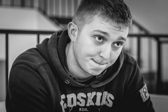 Man in a hoodie with a logo