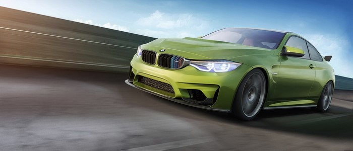 Green BMW M4 Coupe driving on a road