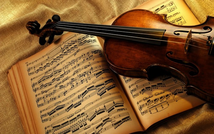 Violin resting on sheet music