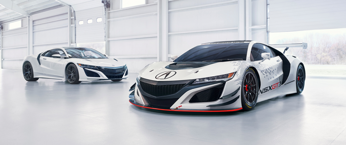 Two white Acura NSX GT3 race cars in a garage
