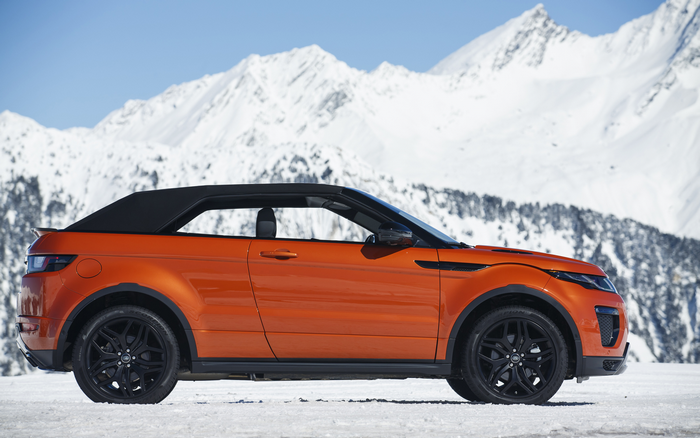 Orange Range Rover Evoque Convertible in snowy mountains