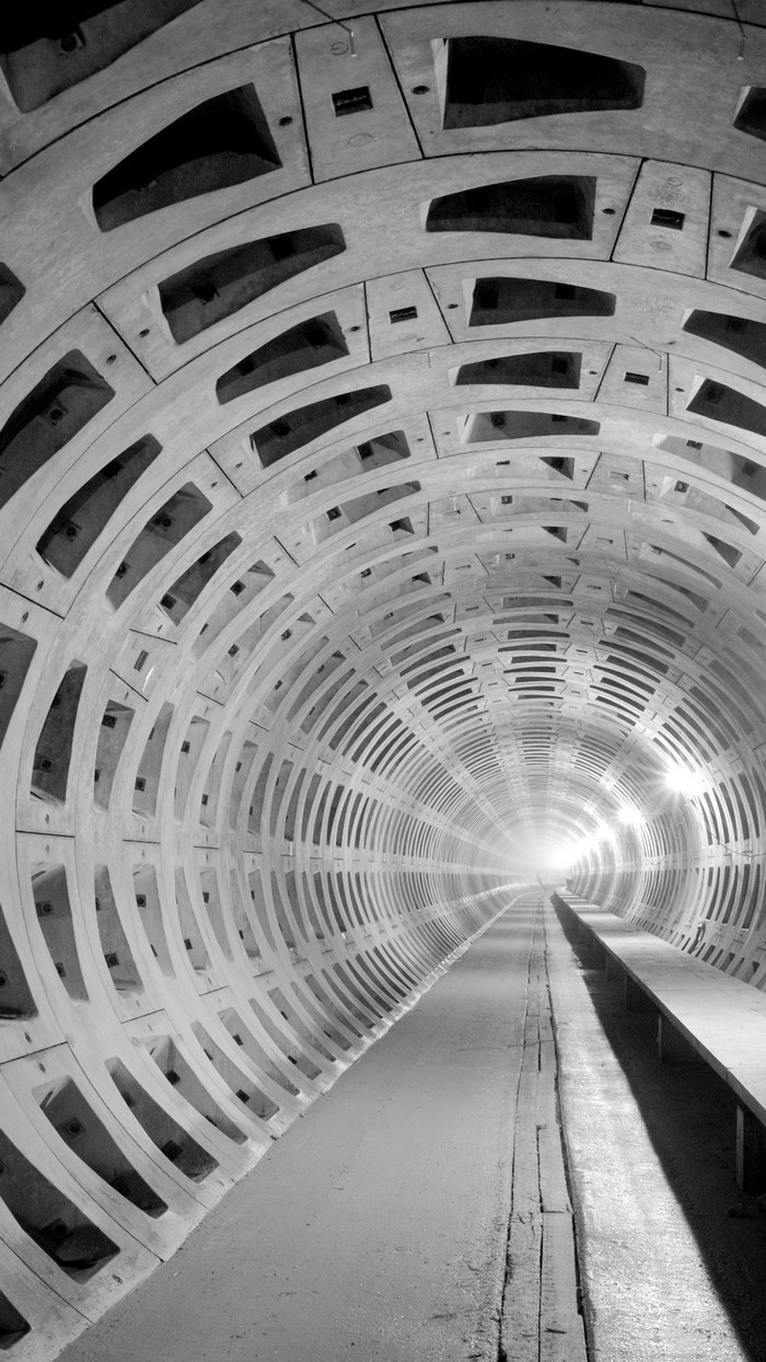 Monochrome tunnel with concrete rings and lights