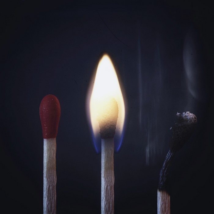 Three matches, one burning, one unlit, one burnt