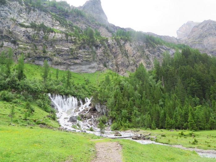 Waterfall cascading down a rocky mountain in the Swiss Alps
