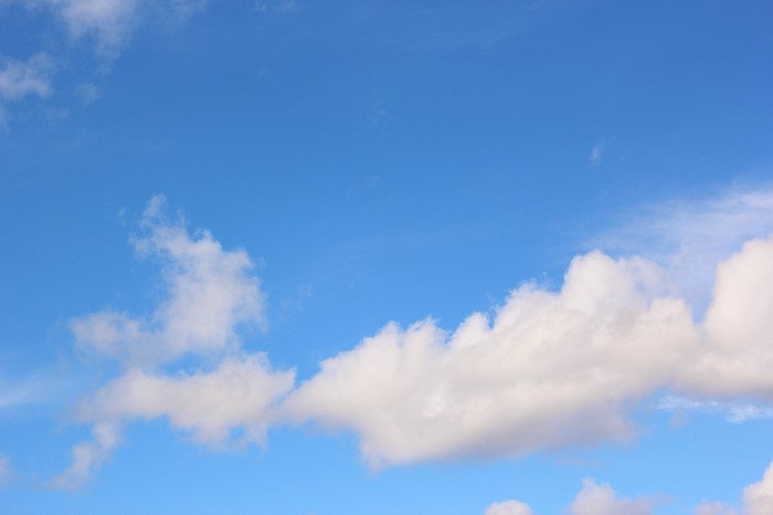 Blue sky with scattered cumulus clouds