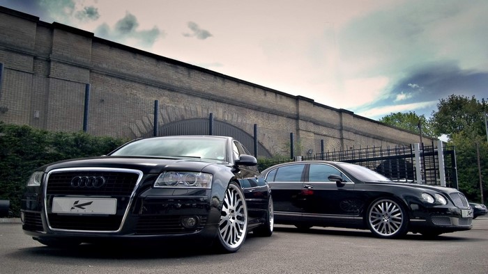 Black Audi and Bentley Sedans parked outdoors