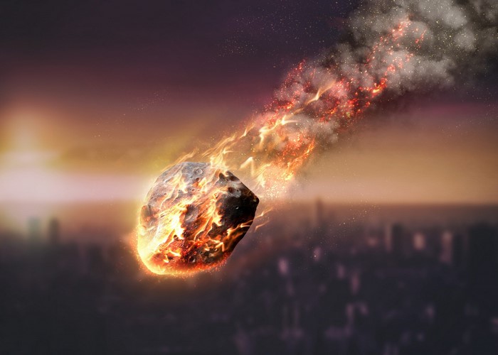 Meteor burning up in Earth's atmosphere over city