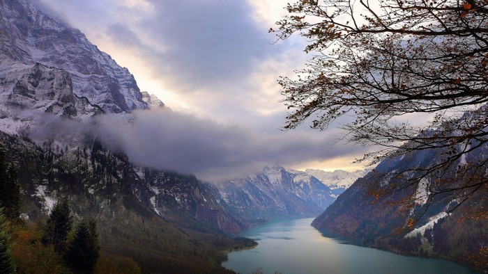 Snowy mountains and a lake in Switzerland during fall