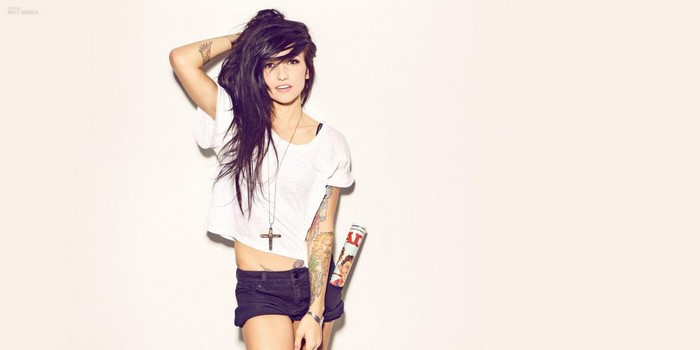 Valerie Poxleitner wearing a white t-shirt and denim shorts
