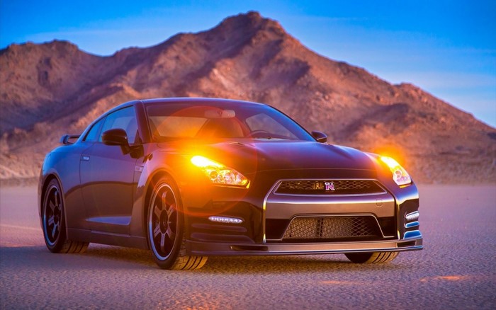 Black Nissan GT-R sports car in desert landscape