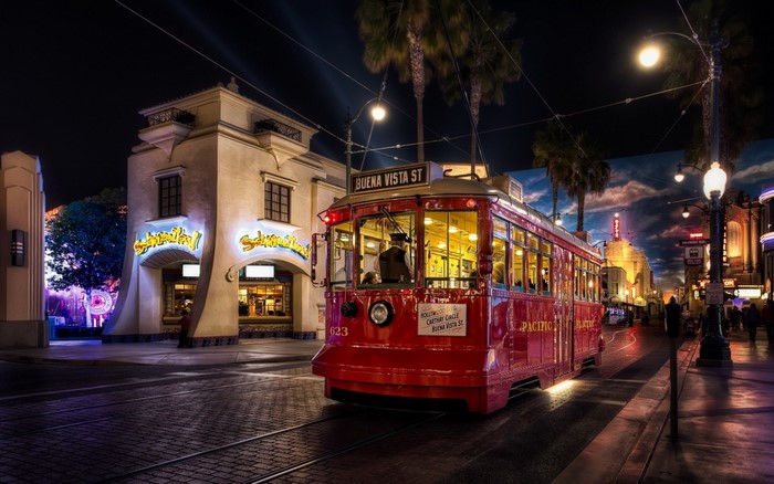 Red trolley car on Buena Vista Street at night