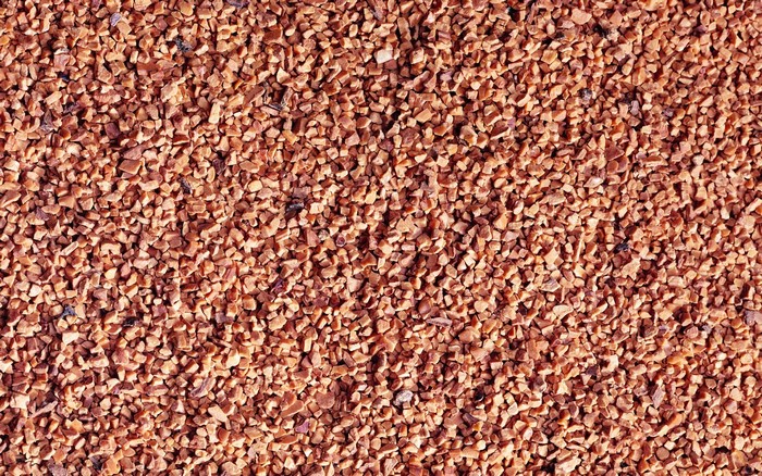 Close-up of small reddish-brown granular material
