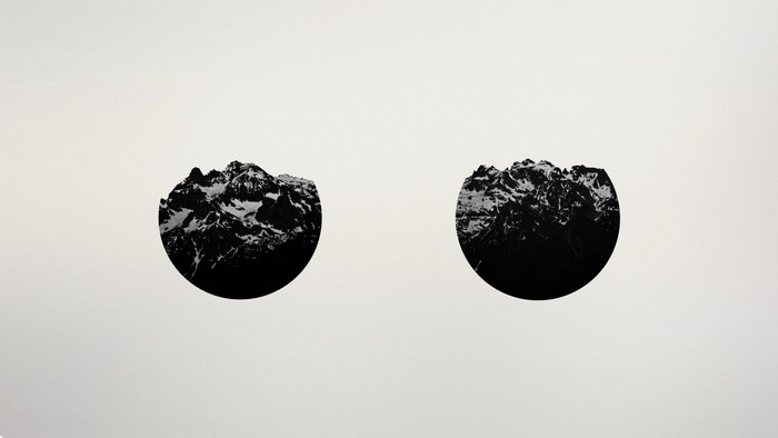 Two circular mountain range illustrations
