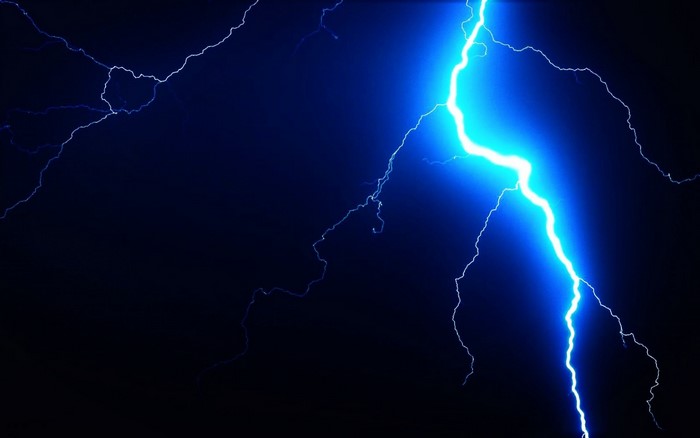 Blue lightning strikes in the dark