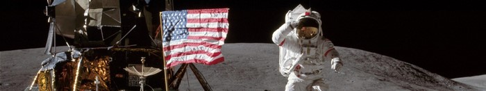 Astronaut salutes near American flag and lunar module on the Moon