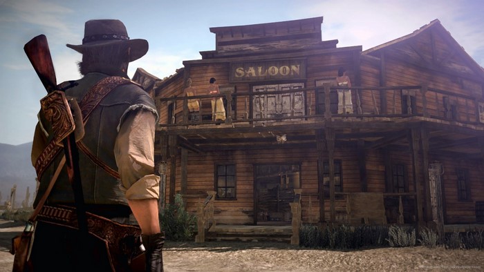 Man with rifle in front of a saloon in Red Dead Redemption