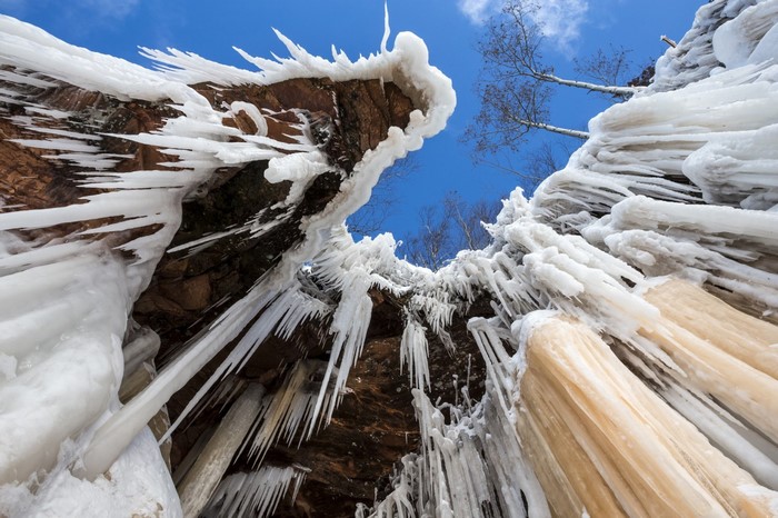 Icicles hanging from a rocky cliff face in winter