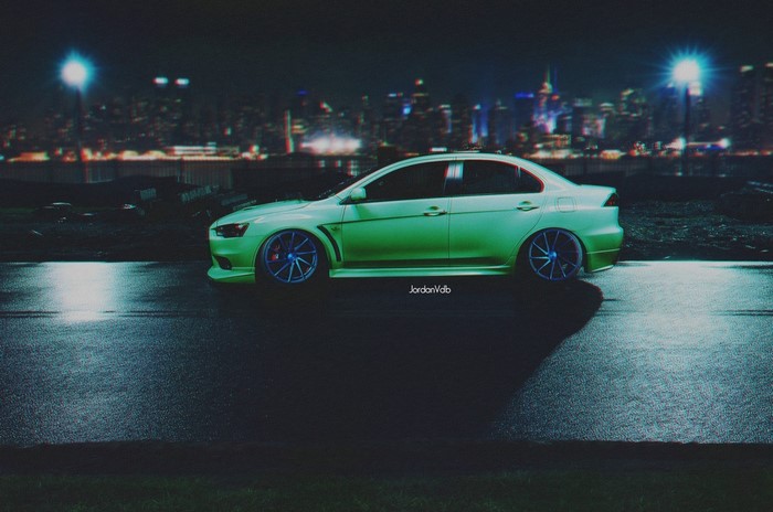 Green Mitsubishi Lancer Evolution X with blue wheels at night