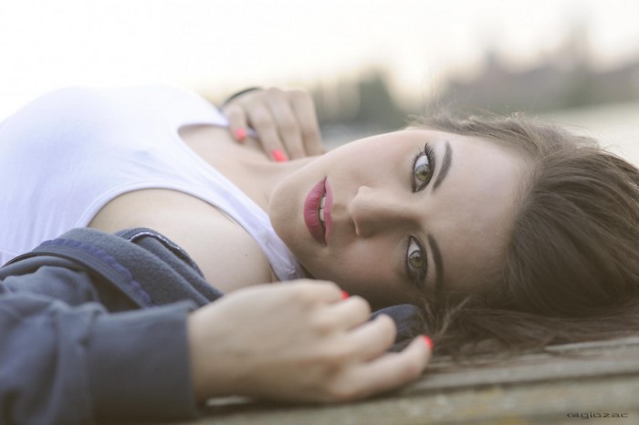 Brunette Woman Lying Down with Sensual Gaze