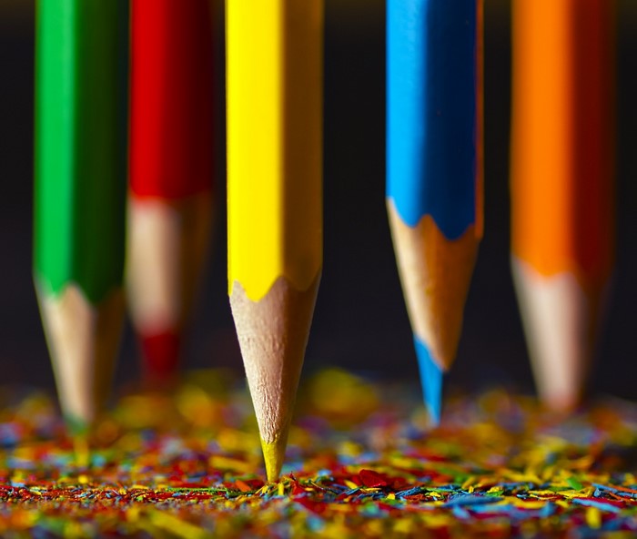 Close up of colored pencils over shavings