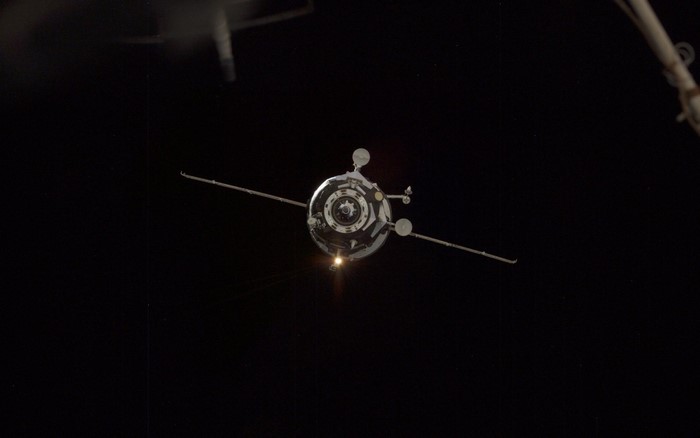 Spacecraft approaching the International Space Station at night